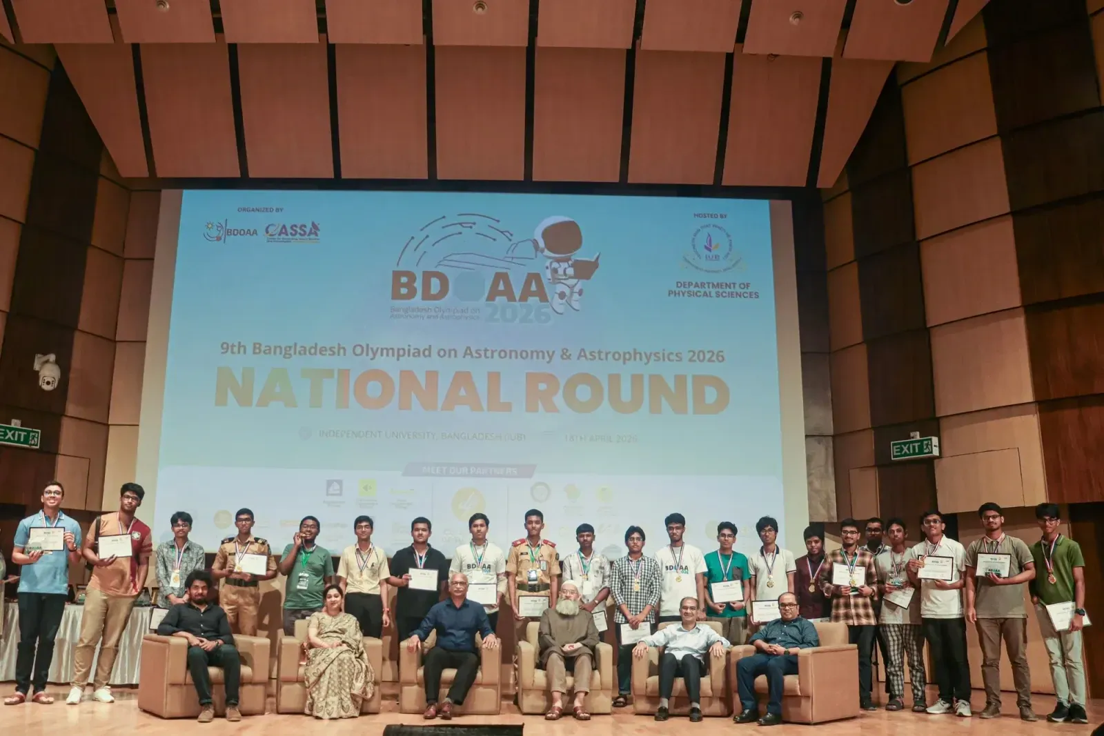 Senior-category winners of the 9th BDOAA National Round holding their certificates beneath the event banner at IUB.