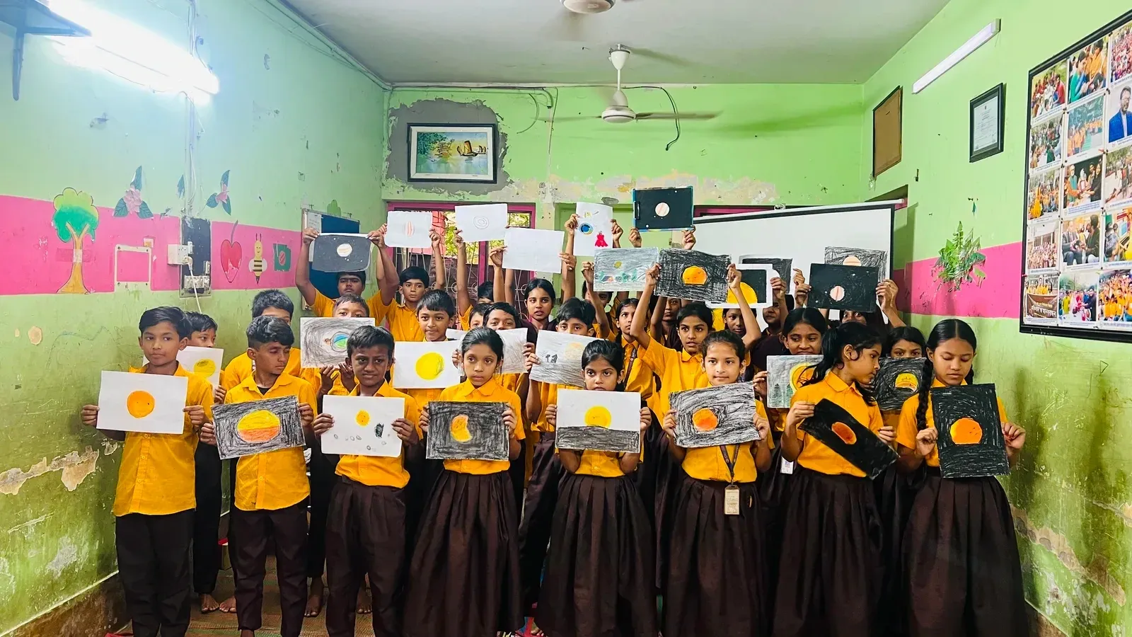 Students holding up their finished sky drawings.