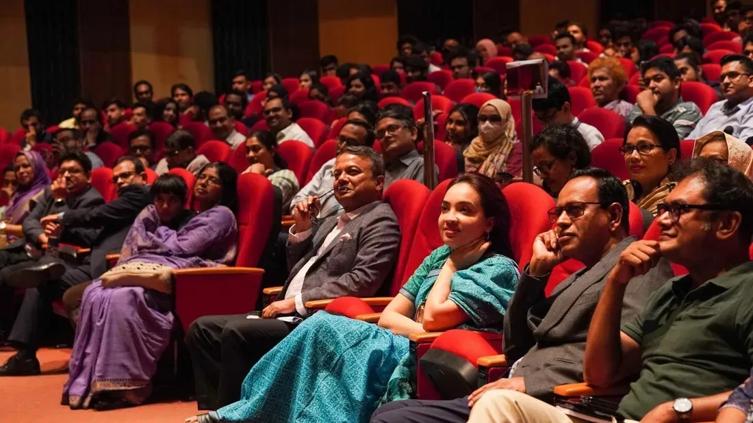 Audience members seated in red auditorium chairs during IUB Astronomy Night I.