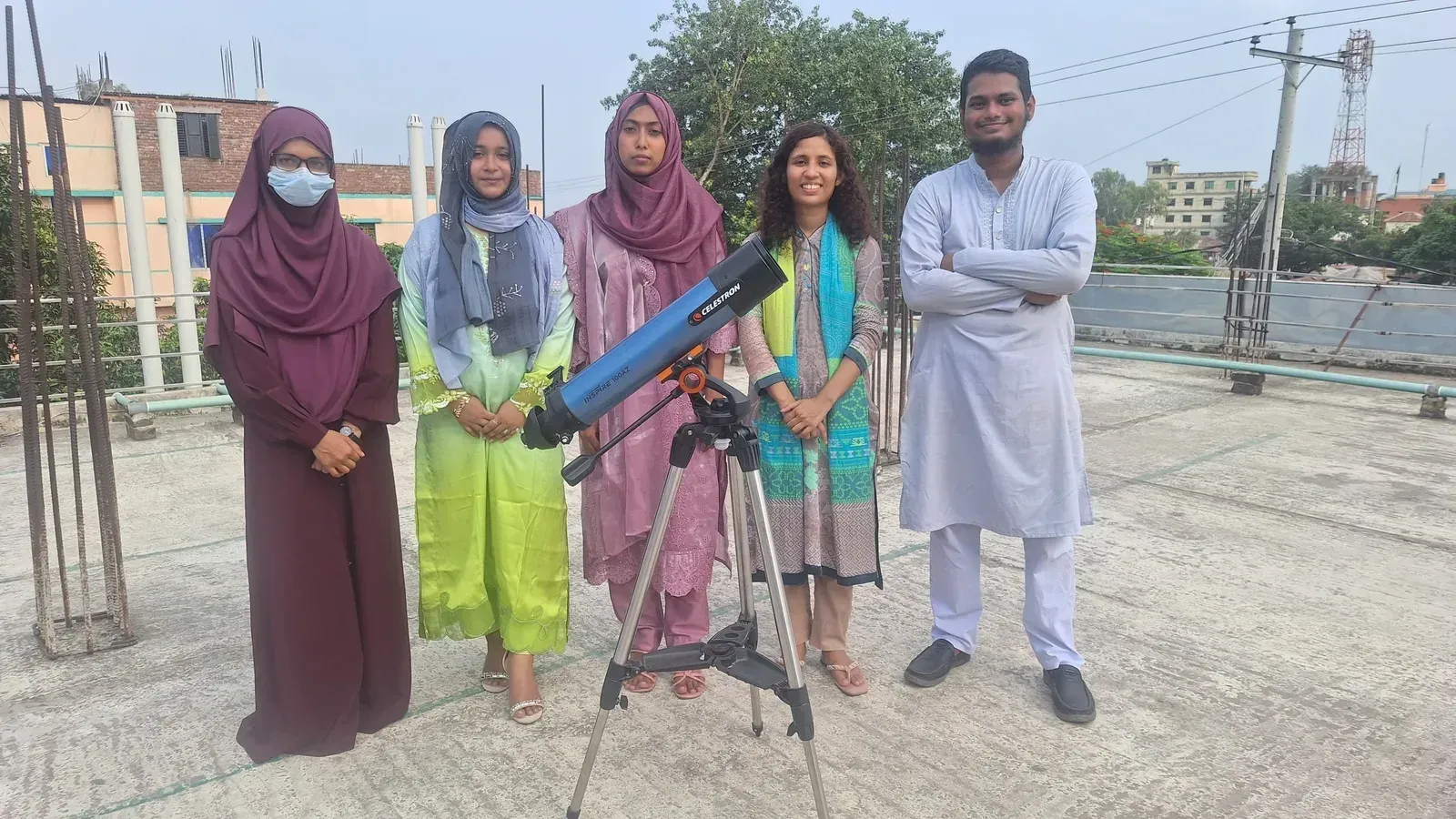 The Durbin volunteer team on the school rooftop with the telescope.