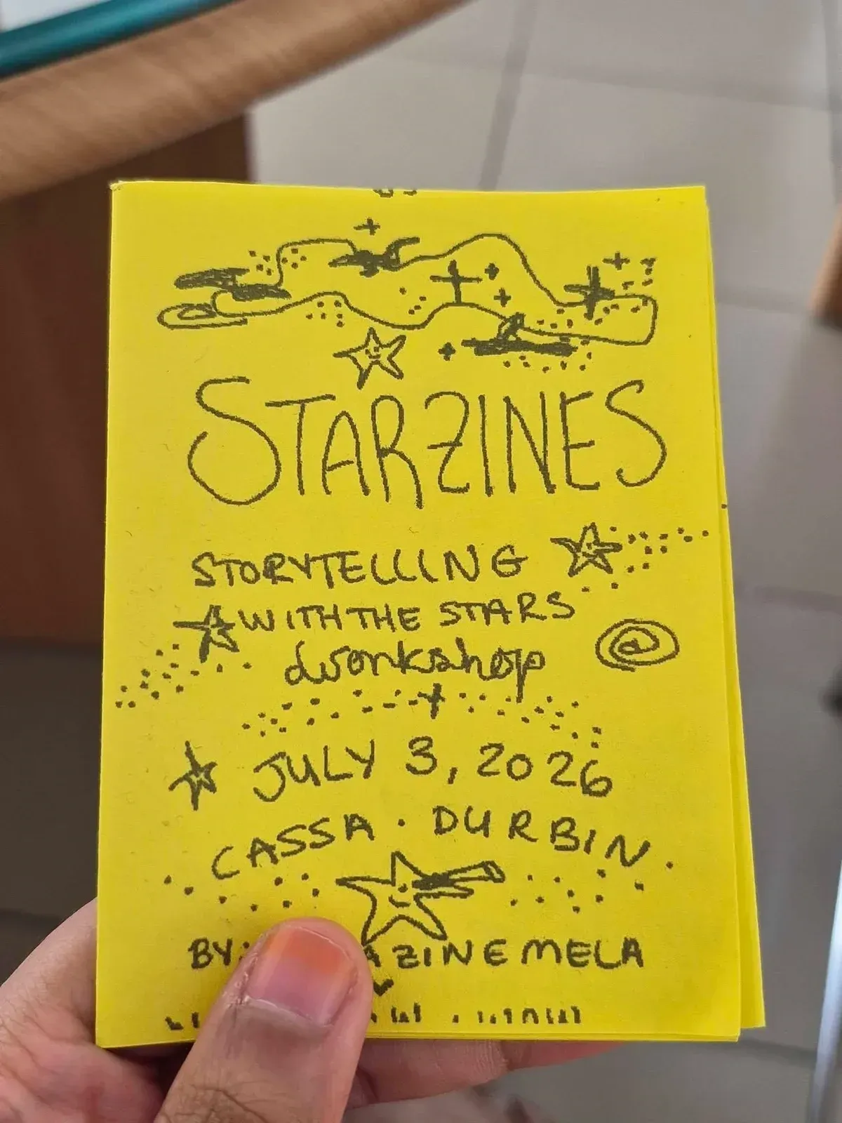A hand-drawn yellow zine cover reading "STARZINES: Storytelling with the Stars workshop, July 3, 2026, CASSA · Durbin".